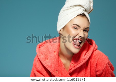 Cheerful attractive funny teen girl clean her teeth in the morning. Over blue background