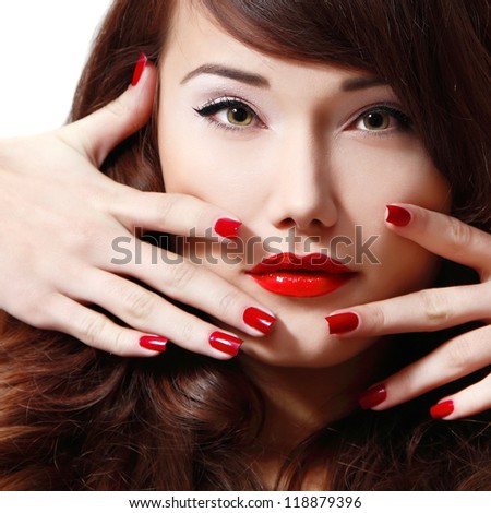 young woman portrait with long hair, red lipstick and manicure, studio shot