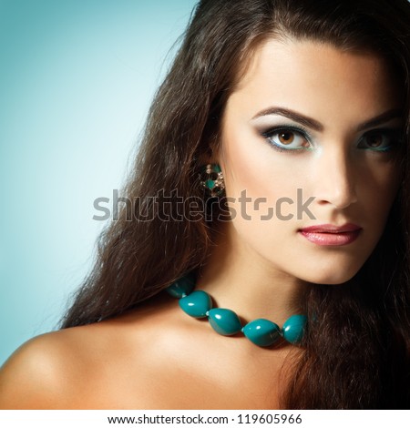 Beauty portrait of beautiful young fresh woman with long brown healthy hair. Over mint background