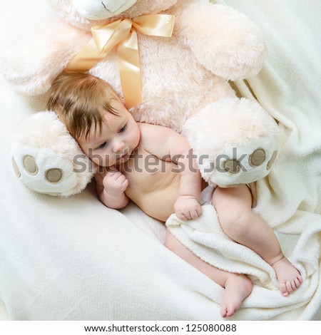 cute funny infant baby boy with big toy bear, beautiful kid\'s portrait closeup