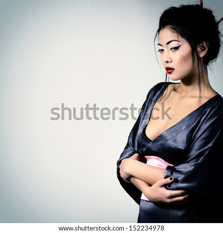 Young beautiful asian woman\'s portrait, studio shot toned and noise added