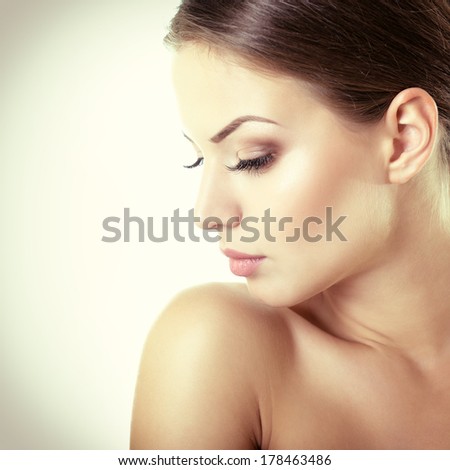 Beauty portrait of young woman with beautiful healthy face in profile, studio shot of attractive girl, toned.