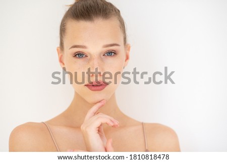 Pretty girl. Portrait of beautiful young woman with clean skin, blue eyes, fair hair and freckles, youth concept, beauty treatment. Cheerful teenager, beauty female face happy smiling over white. Сток-фото © 