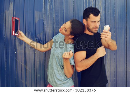 Young couple taking self photo with smartphone. Selfie, social networks, love, friendship, young adult, leisure concept.