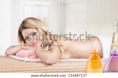 Massage.Spa Salon. Beautiful young woman lying on the massage table. Relax procedure.