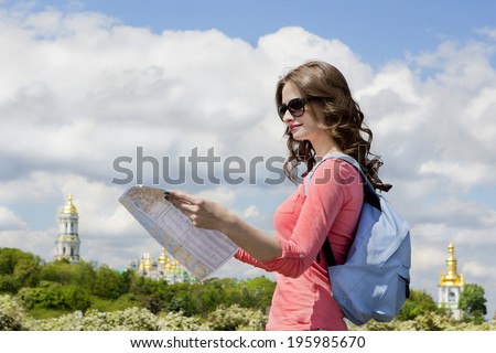 Beautiful young girl with a tourist map walking route attractions in Kiev the capital of Ukraine.