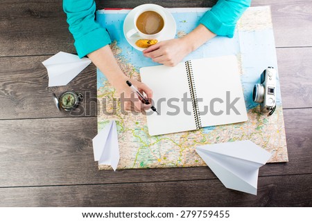 planning travel for a cup of coffee. Empty space in a notebook for blog entries, you can place your text or information. Top view