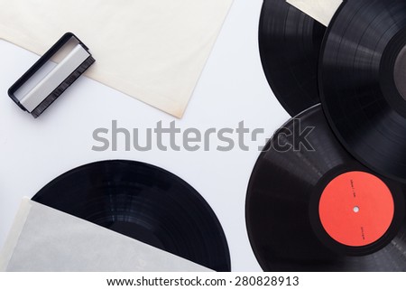 Vinyl records ,record clean brush and paper covers on withe background