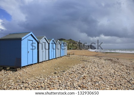 Beach huts on the pebble beach at Charmouth, Dorset, England