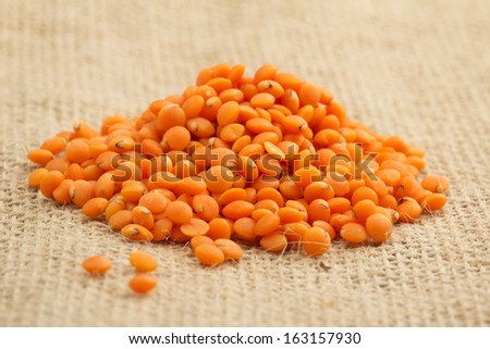 small heap of red lentils on a jute fabric