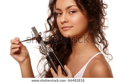 Beauty portrait with curling iron over isolated white background