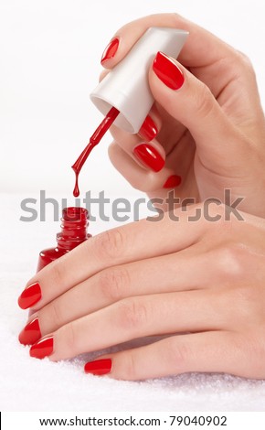 Closeup image of red manicure on top of towel