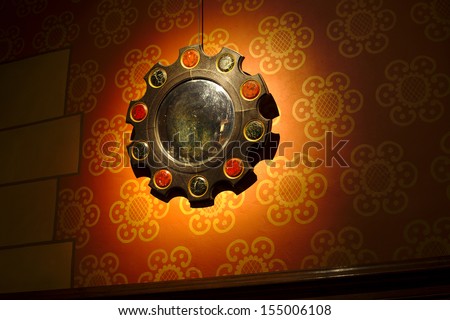 Antique mirror on castle wall