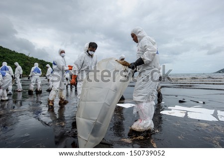 RAYONG, THAILAND - JULY 31: cleaning operations of crude oil due to spill accident on Ao Prao Beach in Samet island on July 31, 2013 in Rayong,Thailand