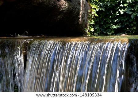 Water spilling over a small dam wall