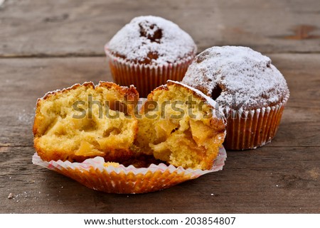 Closeup of an apple muffin on a rustic wooden board.
