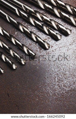 Twist drill bits on old metal texture