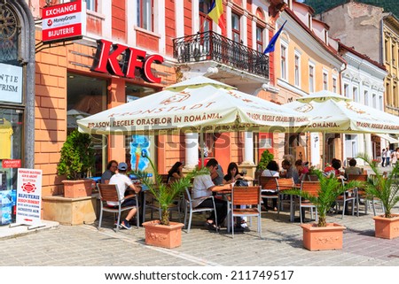 BRASOV, ROMANIA - JULY 15: Council Square on July 15, 2014 in Brasov, Romania. People buying fried chicken at local Kentucky Fried Chicken Restaurant.