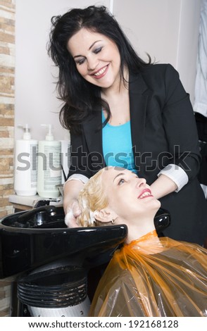 Hairdresser washes blonde hair