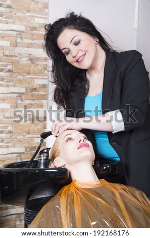 Hairdresser washes blonde hair