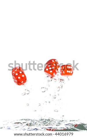 Red transparent dice jumping out of the clear water