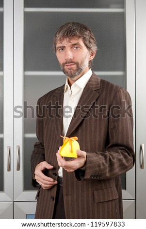 man in business suit stretches box with gift