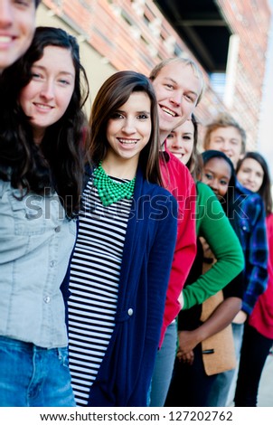 Group of  Diverse students outside smiling in a line