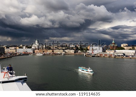 Helsinki seen from the sea and a ship leaving the city before the storm