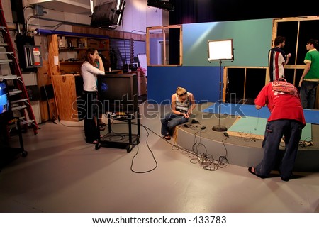 TV production crew preparing studio set