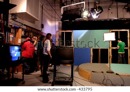 TV production crew preparing studio set.