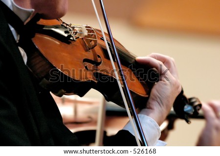 No Model here.  Closeup of musician playing the violin during a symphony - soft fous