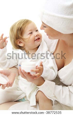 picture of happy mother with baby holding cosmetic cream