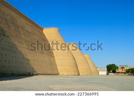 Beautiful sunny day view of ancient fortress - The Ark - against the foreground of blue sky in Historic Center of Bukhara, Uzbekistan, Central Asia