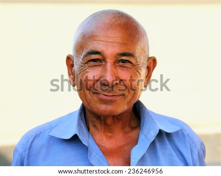 BUKHARA, UZBEKISTAN - JULY 09: Unidentified old man poses for a photo on July 09, 2014 in Historic Center of Bukhara, Uzbekistan. More then 80% of people in Uzbekistan belong to uzbek ethnic group