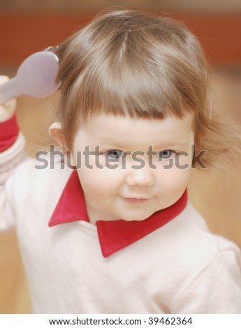 Portrait of baby with hair comb