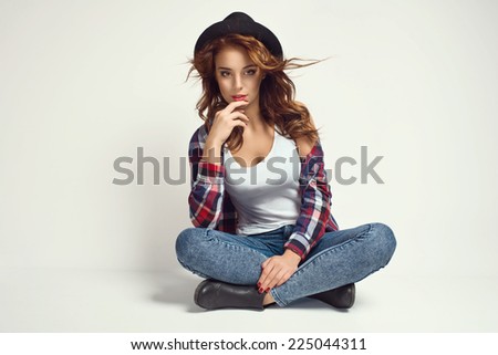 Portrait of beautiful girl in hat. Studio shoot