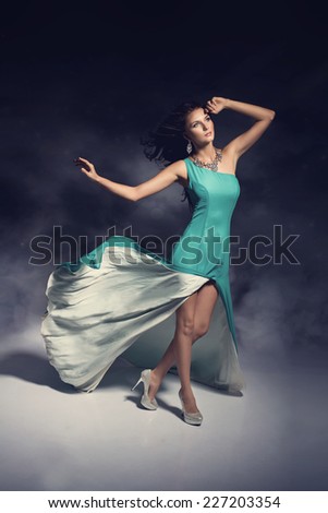 Wonderful brunette woman wearing stunning evening dress. Dream shot