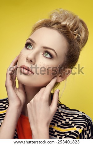 Glamour portrait of beautiful blonde woman model with nice make-up and simple hairstyle. Fashion shiny skin, sexy lip gloss, dark eyebrows, freckles