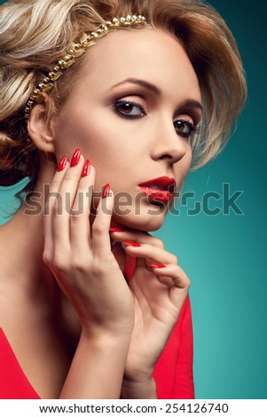 Beautiful woman with nice hair and evening make up. Fashion, red lips, red nails