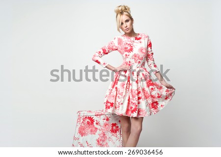 beautiful young blonde woman in nice spring dress, posing in studio. Fashion photo