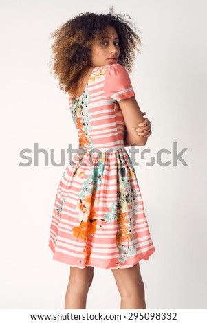 Beautiful young woman in nice colorful dress, high heels sandals. Fashion Photo. Afro hairstyle