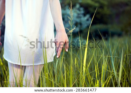 woman touches the grass