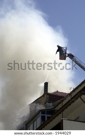 firefighter with hose spraying