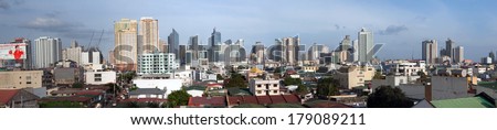 MANILA CITY, PHILIPPINES - JAN. 11, 2014: Panorama of modern skyscrapers and older buildings Jan. 11, 2014 in Manila City, Philippines.