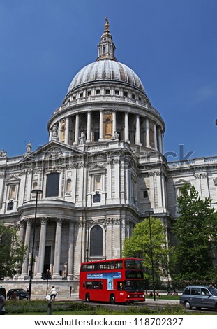 LONDON - MARCH 28: An iconic red bus passes in front of St Paul\'s cathedral in London, England on March 28, 2012. There are over 2 billion bus journeys made in London every year.