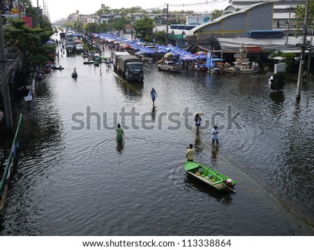 BANGKOK, THAILAND - NOV 17 - Thai flood hits Central of Thailand, overflow water around Sapanmai fresh market  on November 17, 2011 in Bangkok, Thailand