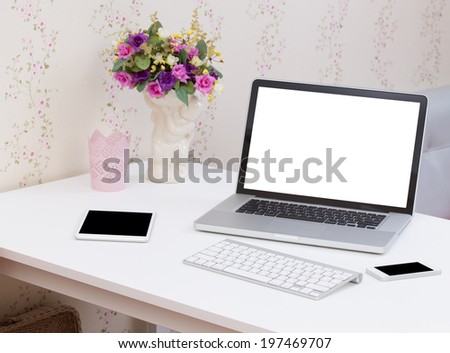 Blank screen laptop computer on the white table