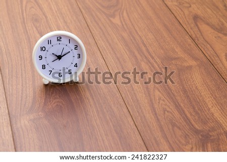 White clock on wood background
