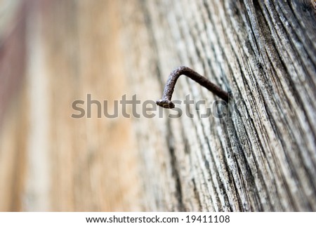 board of wood with old rusty nail