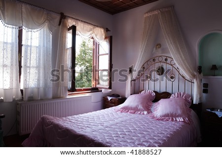 Two brightly-lit window in a old style romantic bed room